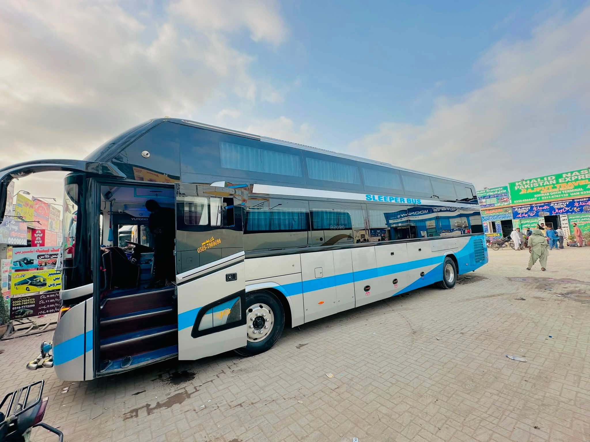 Sleeper bus with doors open at the terminal